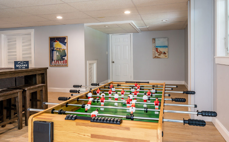 The lower level is the perfect hangout space, with a 55" TV, games and puzzles, and foosball.