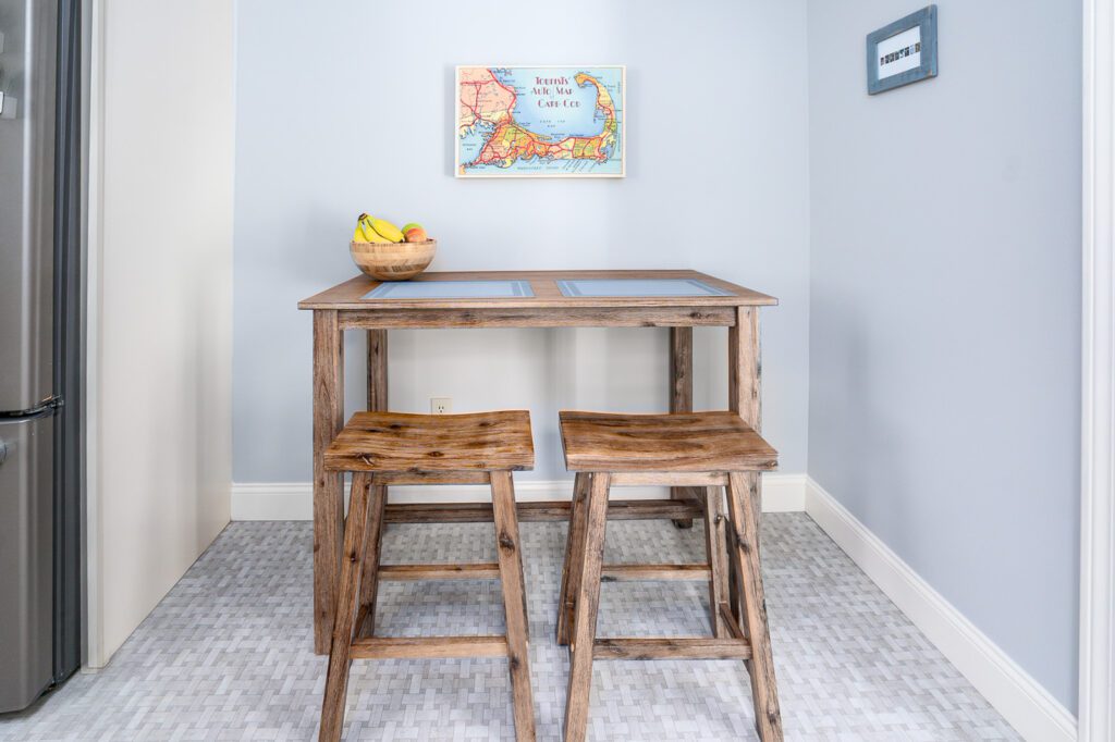 The kitchen also features a breakfast nook with a small table and stools.