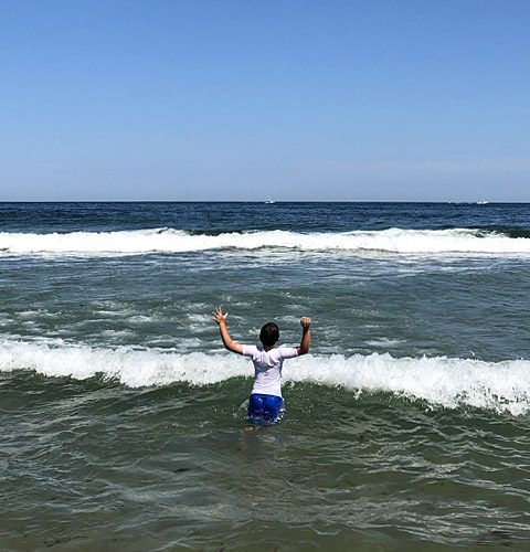 Child enjoying the surf at Nauset Beach in Orleans, MA.